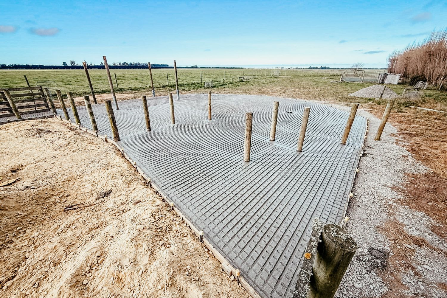 Grooved concrete cattle yard with post-and-rail fencing, Ashburton