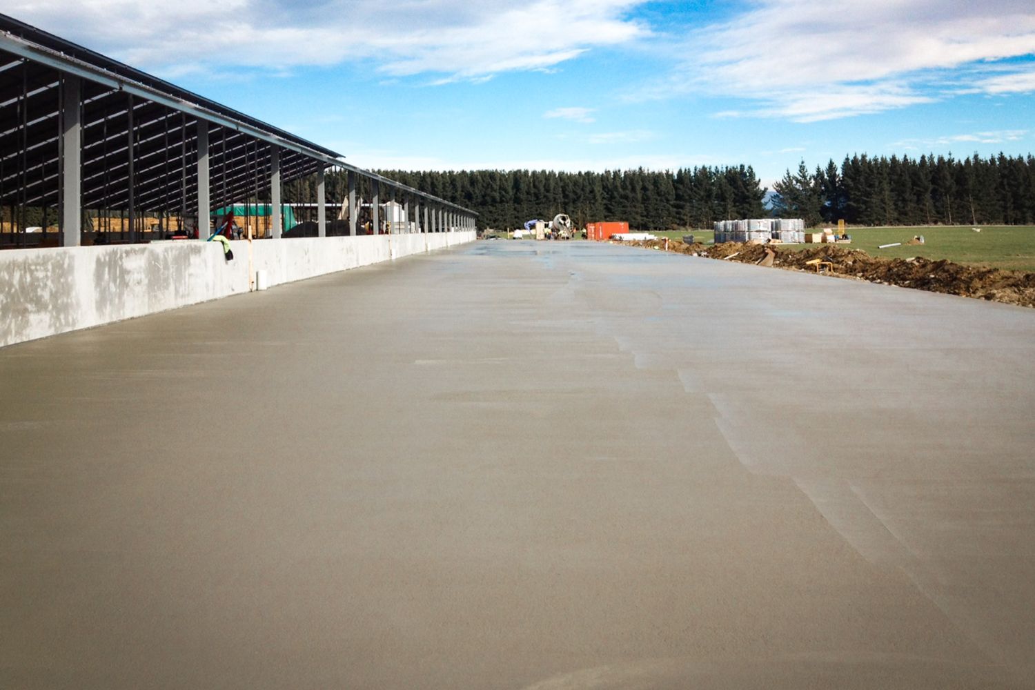 Concrete feed pad under a long open-sided farm shelter, Ashburton